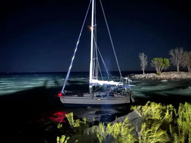 Photo of a sailboat on the rocks before it sinks at my fishing hole. About 0200 hrs.